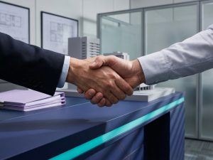 Professional business handshake between polished hands in modern office with blue desk and turquoise lighting accents